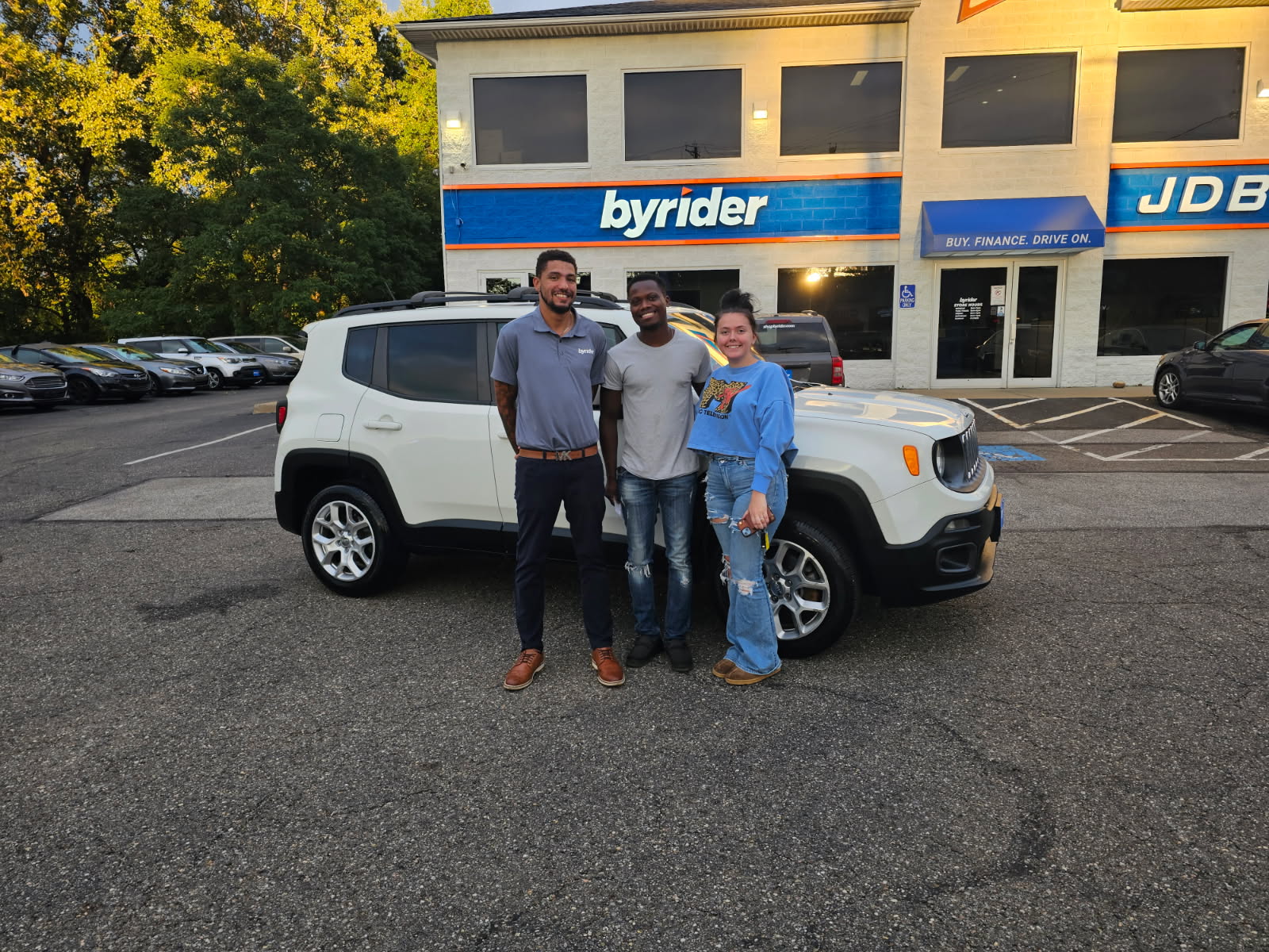 Byrider customers with their used Jeep Renegade at the Akron, Ohio dealership