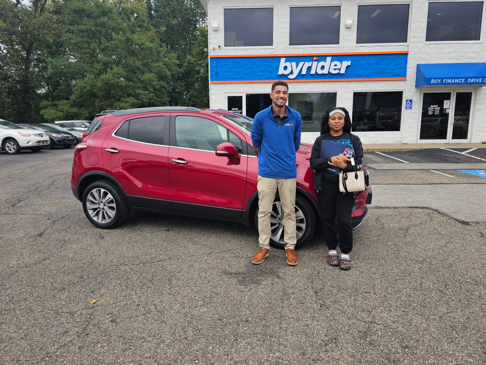 Byrider Akron customers with their used Buick Encore in Akron, Ohio