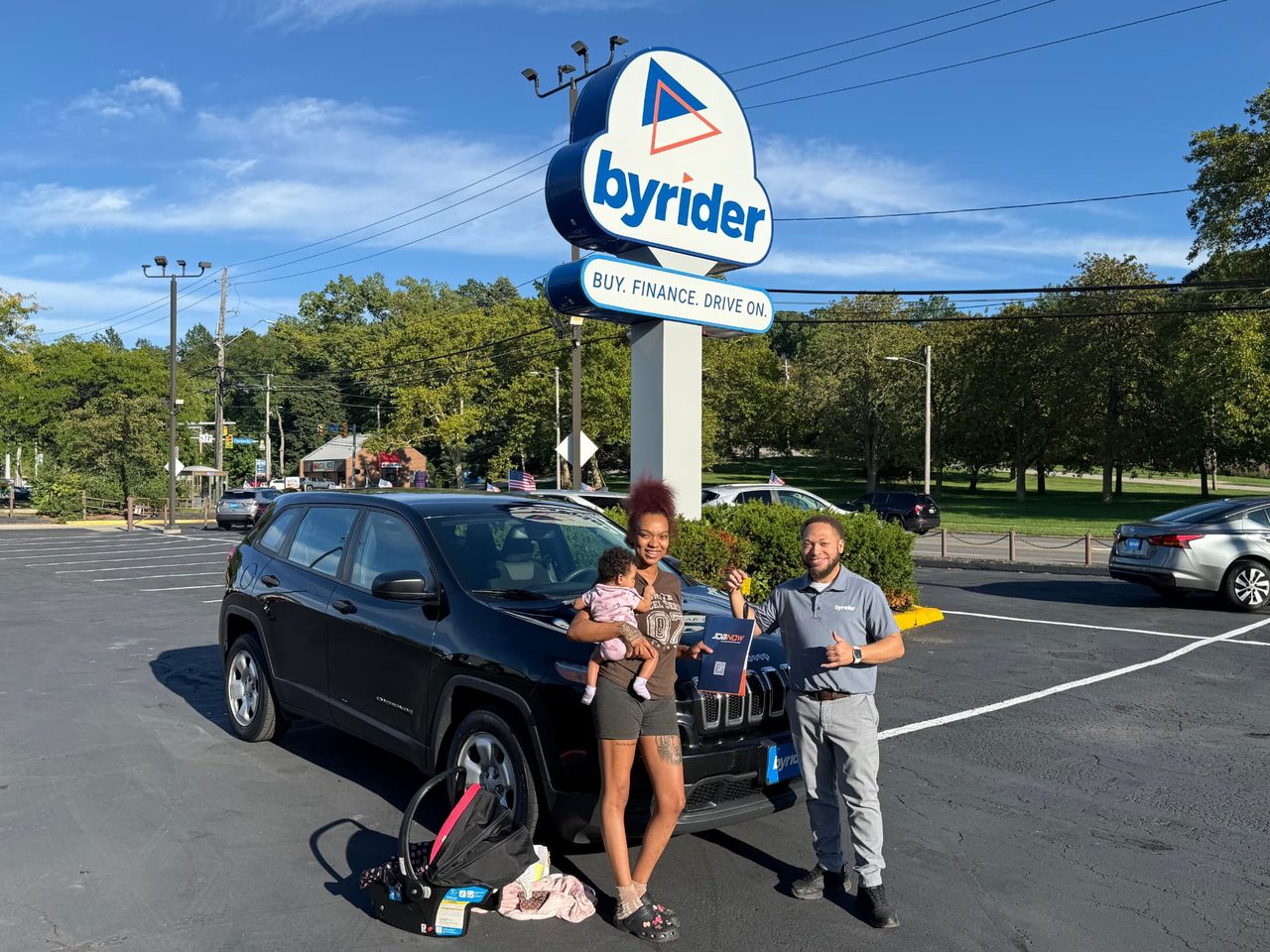 Byrider Euclid customer and salesperson beside their used Jeep Cherokee at the Euclid, Ohio dealership