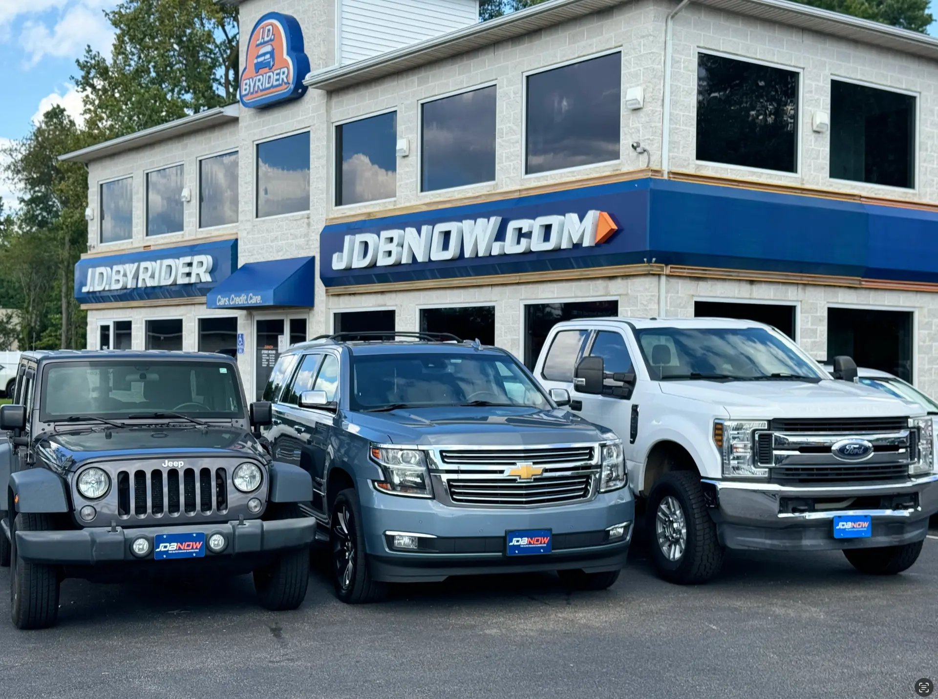 Byrider Akron used car dealership storefront at 777 Canton Rd, Akron, Ohio, with a Jeep, Chevrolet SUV and Ford truck on the lot