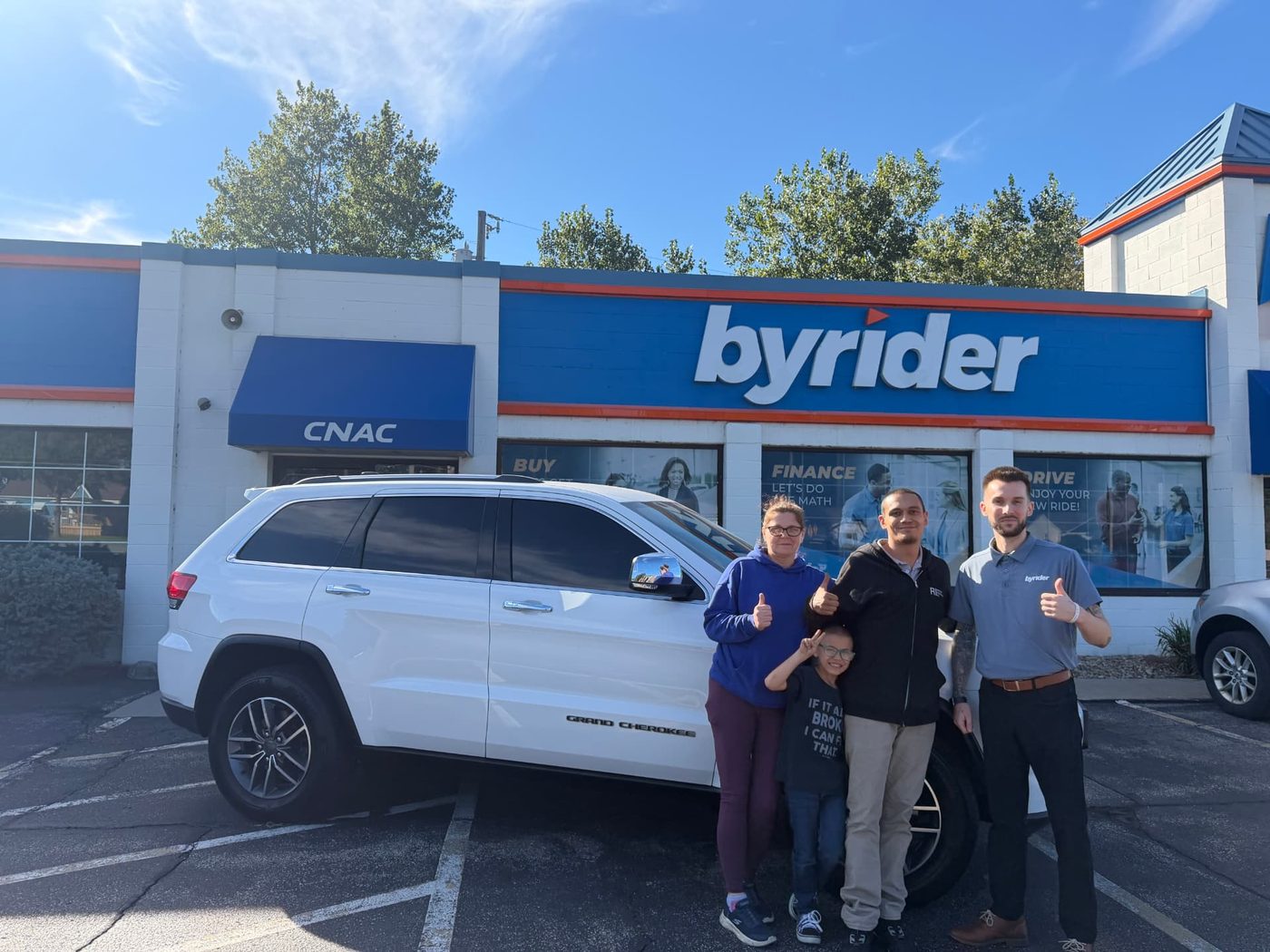 Byrider Amherst customers with their used Jeep Grand Cherokee at the Amherst, Ohio dealership