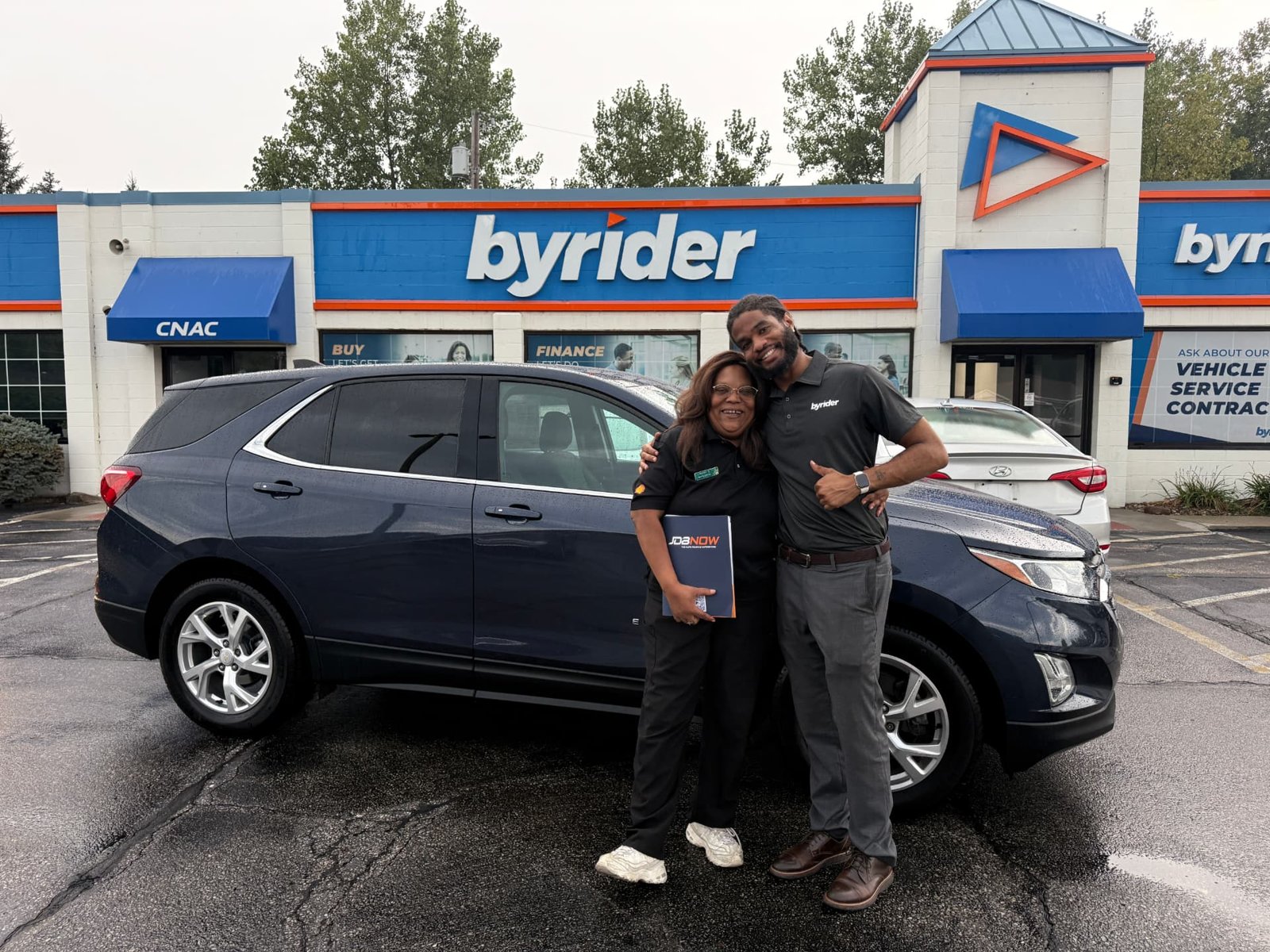 Byrider Amherst customer and salesperson with their used Chevrolet Equinox at the Amherst, Ohio dealership
